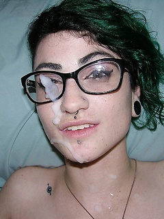 Green-haired and bespectacled slut lets a hung fellow cum on her pretty face